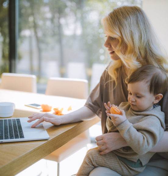 woman-carrying-her-baby-and-working-on-a-laptop-4079281-scaled-551x580.jpg